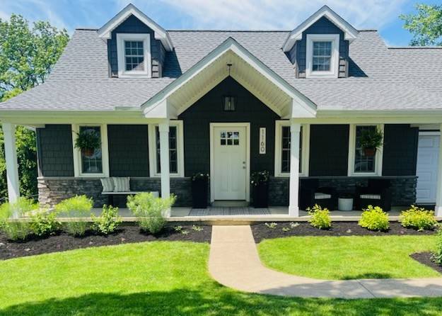 Exterior front view of cape cod with large gable over the front door.